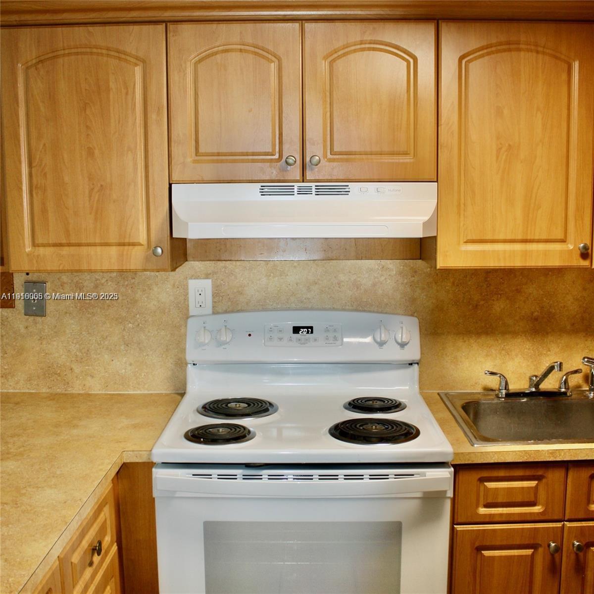 2079 West 54th Terrace, Unit 29 Hialeah, FL 33016 - Photo 18 of 43 a stove top oven sitting inside of a kitchen