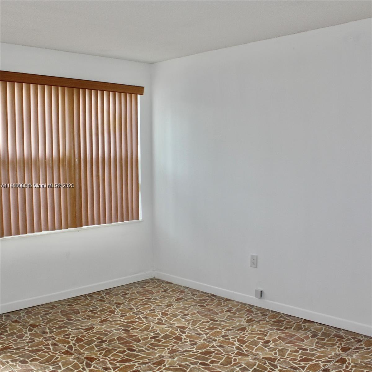 2079 West 54th Terrace, Unit 29 Hialeah, FL 33016 - Photo 23 of 43 a view of an empty room with a window