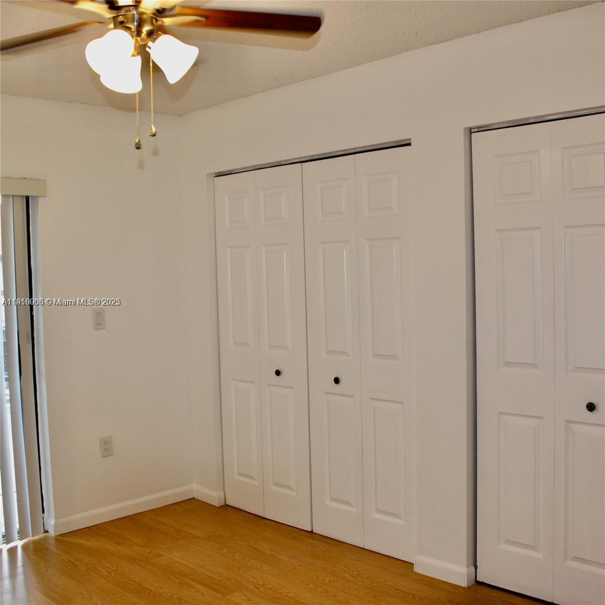 2079 West 54th Terrace, Unit 29 Hialeah, FL 33016 - Photo 30 of 43 a view of a room with a chandelier fan and closet