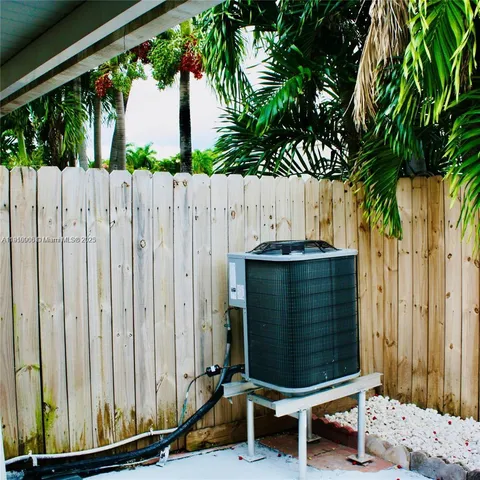 a bench sitting in front of a wooden fence