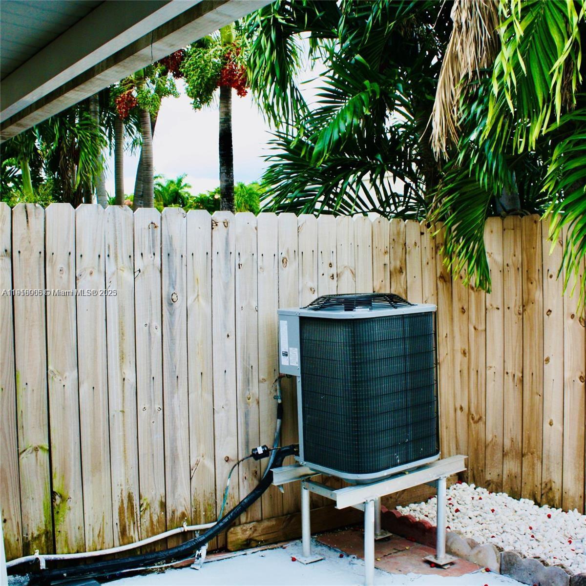 2079 West 54th Terrace, Unit 29 Hialeah, FL 33016 - Photo 4 of 43 a bench sitting in front of a wooden fence