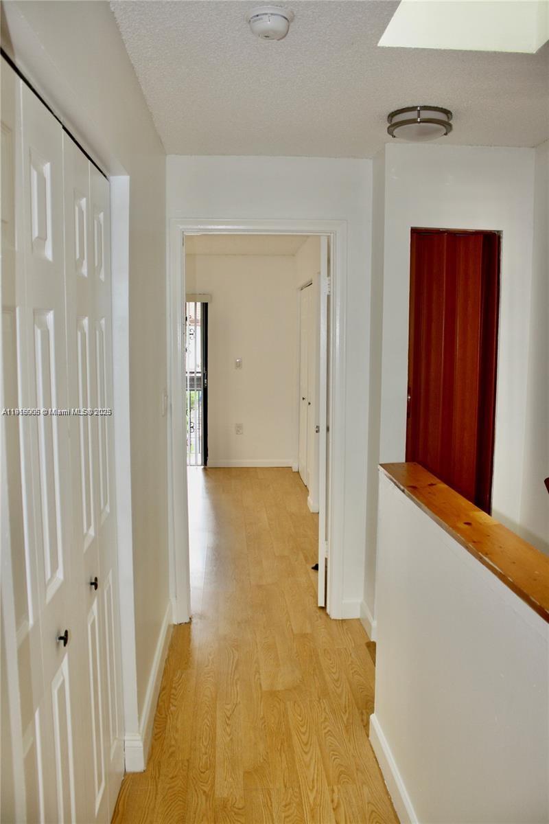 2079 West 54th Terrace, Unit 29 Hialeah, FL 33016 - Photo 41 of 43 a view of a hallway with wooden floor