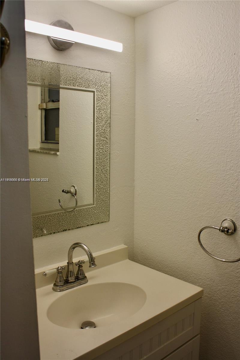 2079 West 54th Terrace, Unit 29 Hialeah, FL 33016 - Photo 10 of 43 a bathroom with a sink and mirror