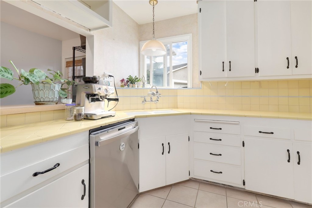 234 North Martha Place Fullerton, CA 92833 - Photo 12 of 46 a kitchen with granite countertop white cabinets and white appliances