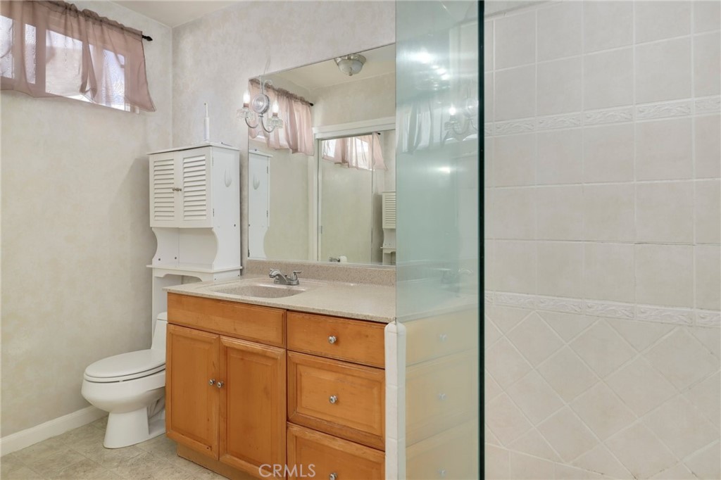234 North Martha Place Fullerton, CA 92833 - Photo 17 of 46 a bathroom with a granite countertop toilet sink and mirror