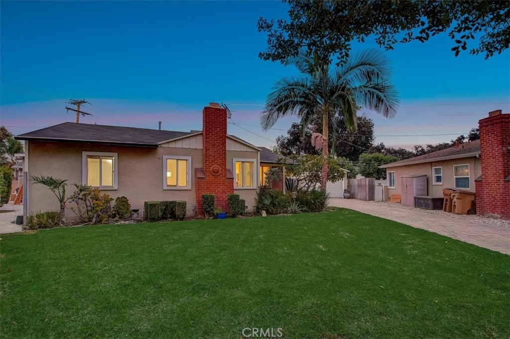 234 North Martha Place Fullerton, CA 92833 - Photo 3 of 46 a front view of a house with a garden and yard