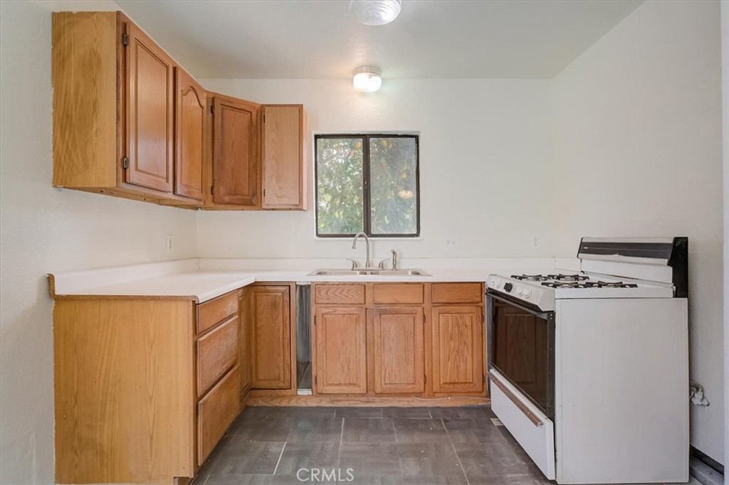 234 North Martha Place Fullerton, CA 92833 - Photo 36 of 46 a kitchen with granite countertop a sink stove and refrigerator