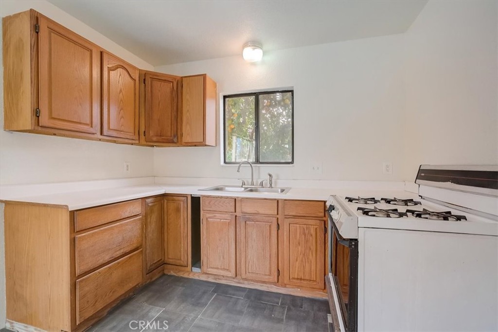 234 North Martha Place Fullerton, CA 92833 - Photo 37 of 46 a kitchen with granite countertop cabinets a sink and appliances