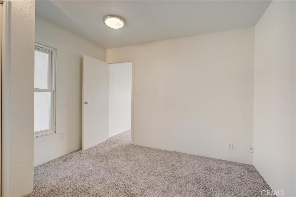 234 North Martha Place Fullerton, CA 92833 - Photo 40 of 46 an empty room with a ceiling fan and a window