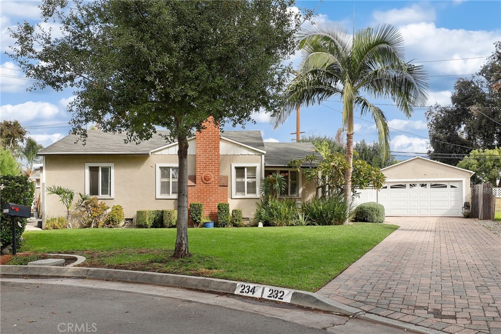 234 North Martha Place Fullerton, CA 92833 - Photo 6 of 46 a front view of a house with a garden and trees