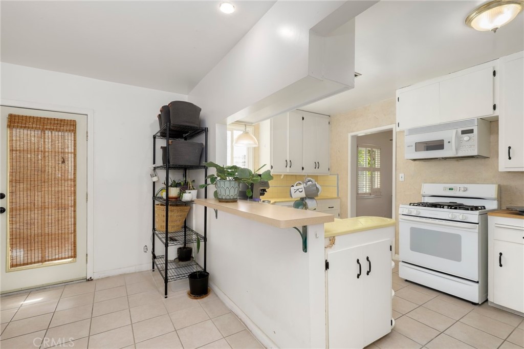 234 North Martha Place Fullerton, CA 92833 - Photo 10 of 46 a kitchen with white cabinets and appliances
