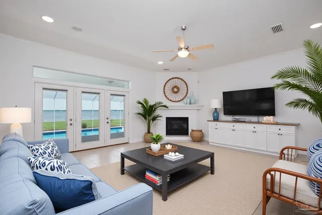 a living room with furniture a flat screen tv and a fireplace