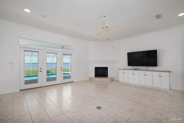 a view of an empty room with a fireplace and a flat screen tv