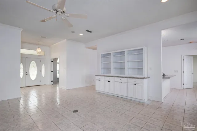 a view of an empty room with a cabinet and a window