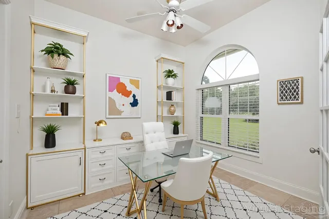 an empty room with a fireplace mirror and windows