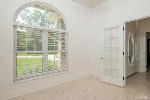 a kitchen with stainless steel appliances granite countertop grey cabinets a stove a sink and a microwave