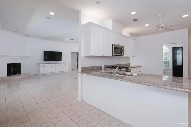 a kitchen with a refrigerator and cabinets