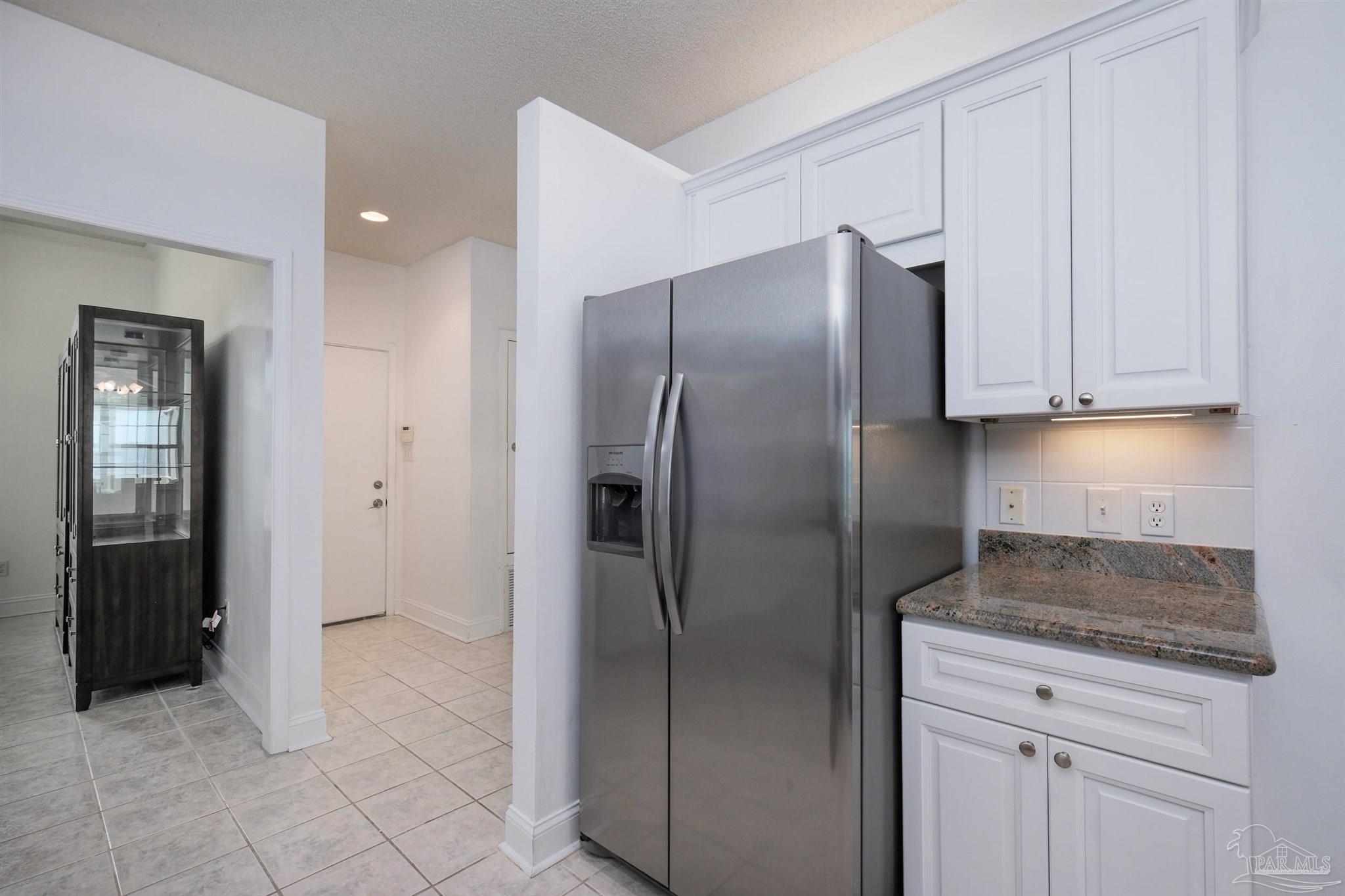 5450 North Shore Road Pensacola, FL 32507 - Photo 25 of 62 a kitchen with a refrigerator and cabinets