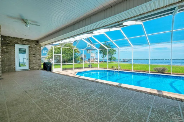 a living room with furniture a window and a potted plant