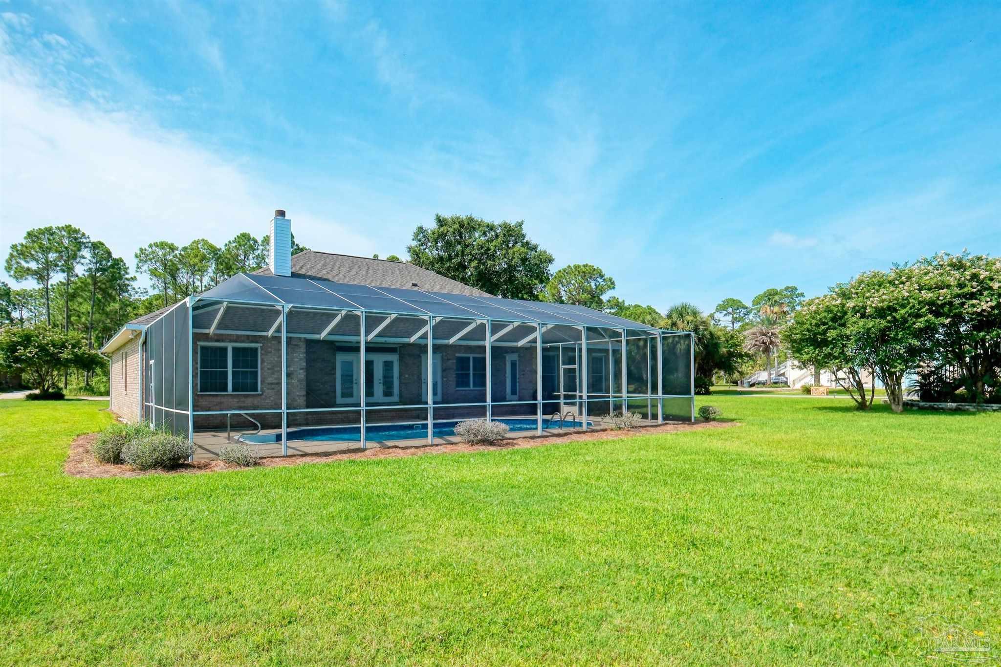 5450 North Shore Road Pensacola, FL 32507 - Photo 5 of 62 a view of a house with a backyard