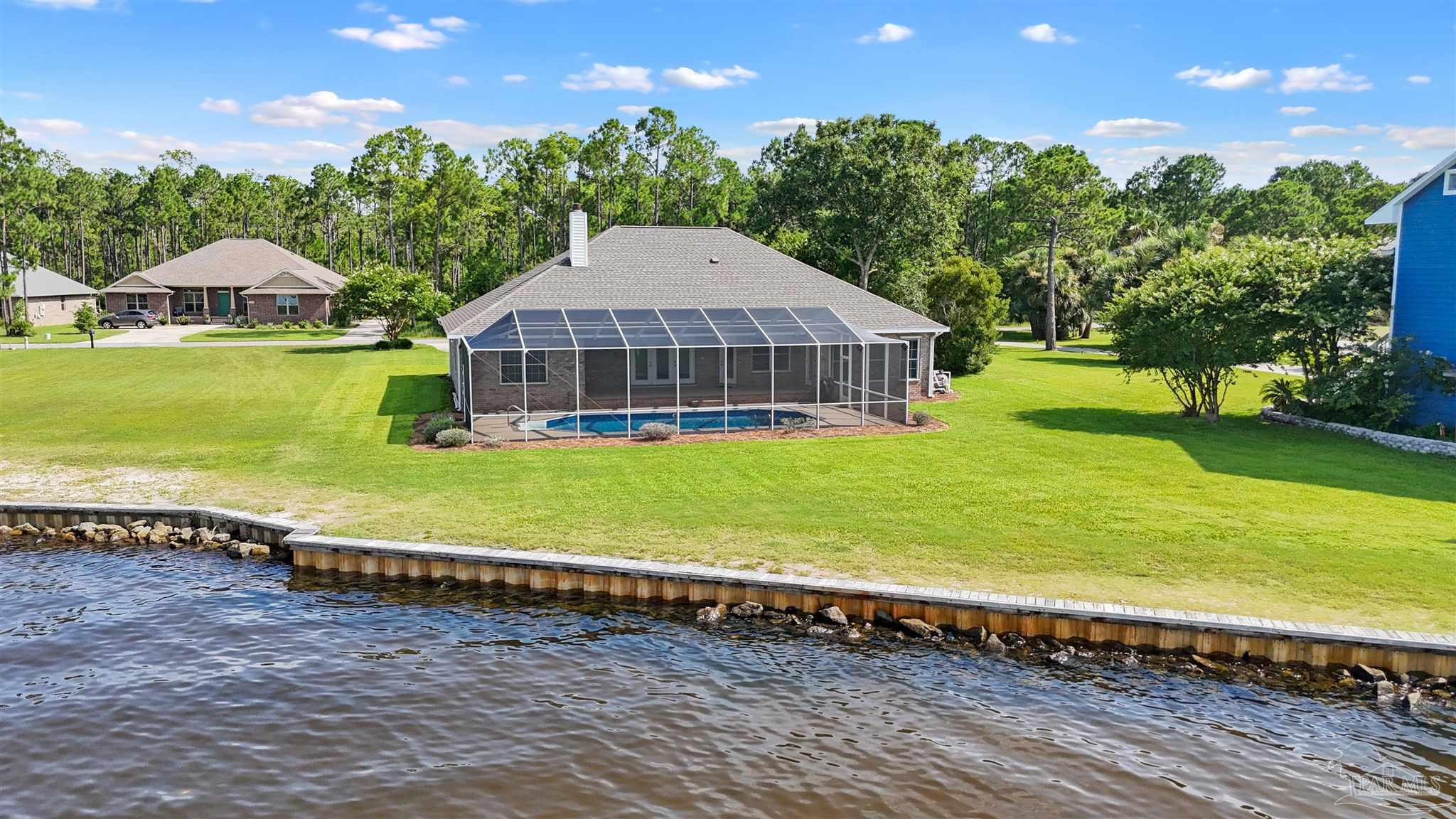 5450 North Shore Road Pensacola, FL 32507 - Photo 55 of 62 a view of a house with a yard and sitting area