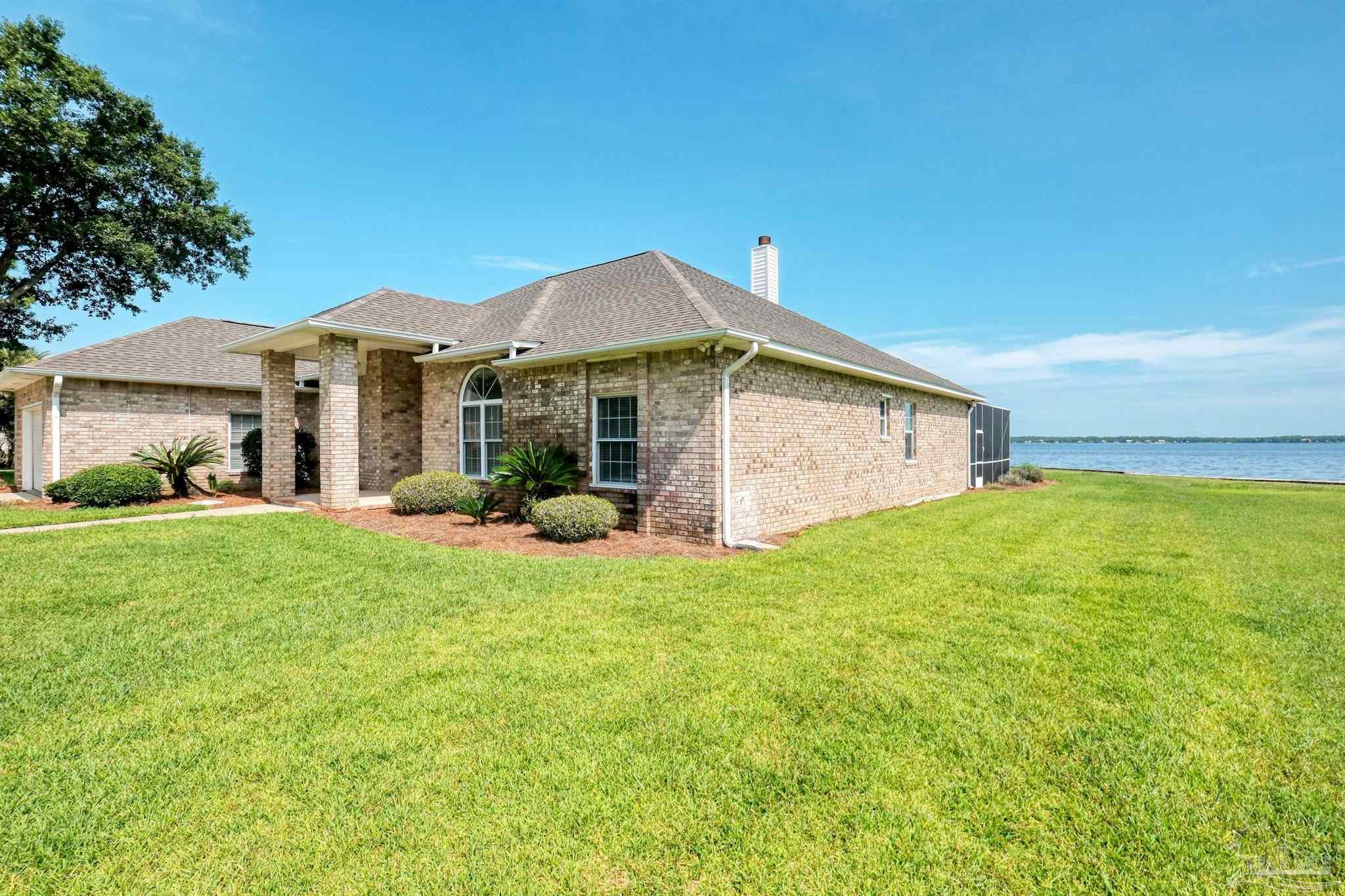 5450 North Shore Road Pensacola, FL 32507 - Photo 6 of 62 a view of a house with backyard and porch