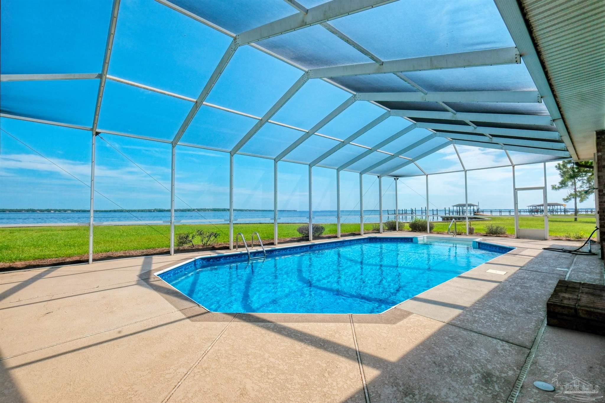 5450 North Shore Road Pensacola, FL 32507 - Photo 7 of 62 a view of a backyard with swimming pool