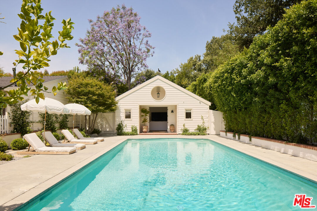 a swimming pool with outdoor seating and yard