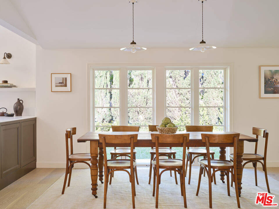 17333 Rancho Street Encino, CA 91316 - Photo 11 of 30 a view of a dining room with furniture large windows and wooden floor