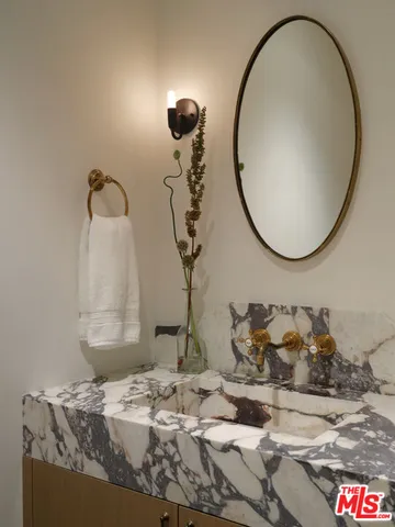 a bedroom with a bed and paintings on the wall