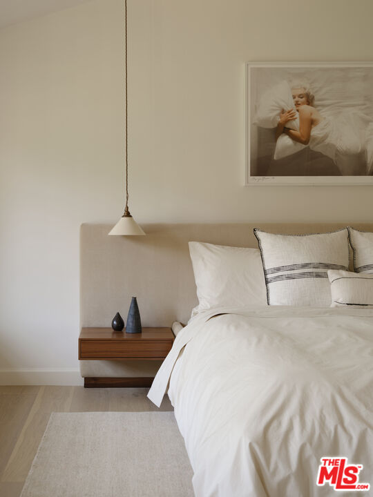 17333 Rancho Street Encino, CA 91316 - Photo 16 of 30 a bedroom with a bed and wall painting