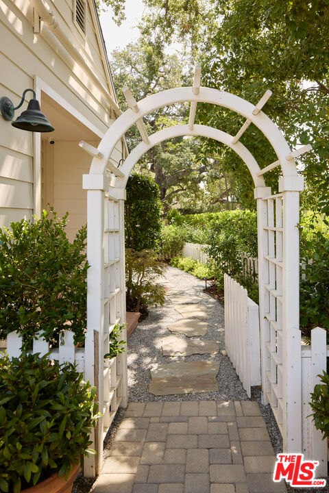 17333 Rancho Street Encino, CA 91316 - Photo 21 of 30 a front view of a house with garden