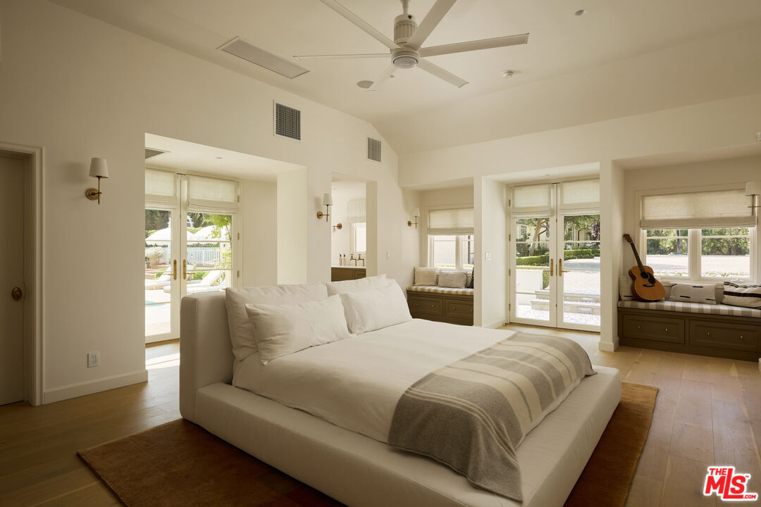 17333 Rancho Street Encino, CA 91316 - Photo 26 of 30 a spacious bedroom with a bed a couch and dresser