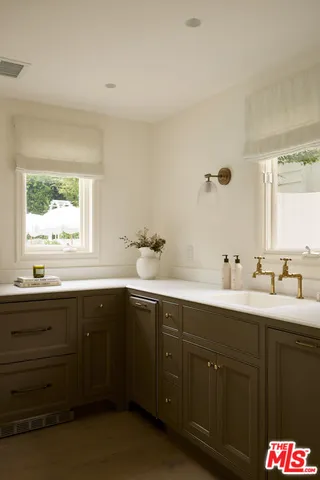a bathroom with a shower sink and mirror