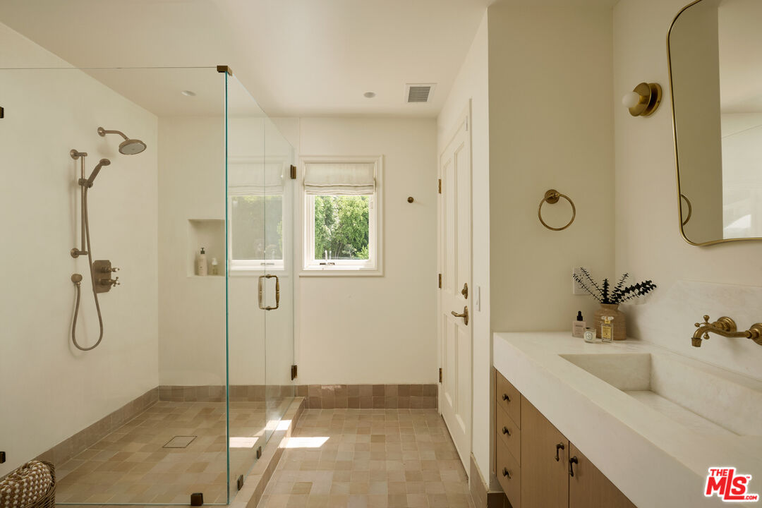 17333 Rancho Street Encino, CA 91316 - Photo 29 of 30 a bathroom with a shower sink and mirror