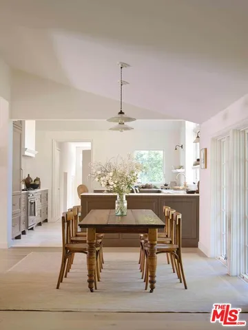 a view of a dining room with furniture large windows and wooden floor