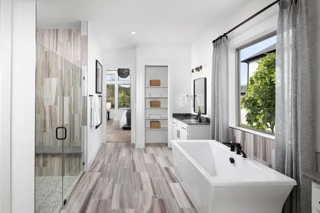 a bathroom with a bathtub a sink and a shower