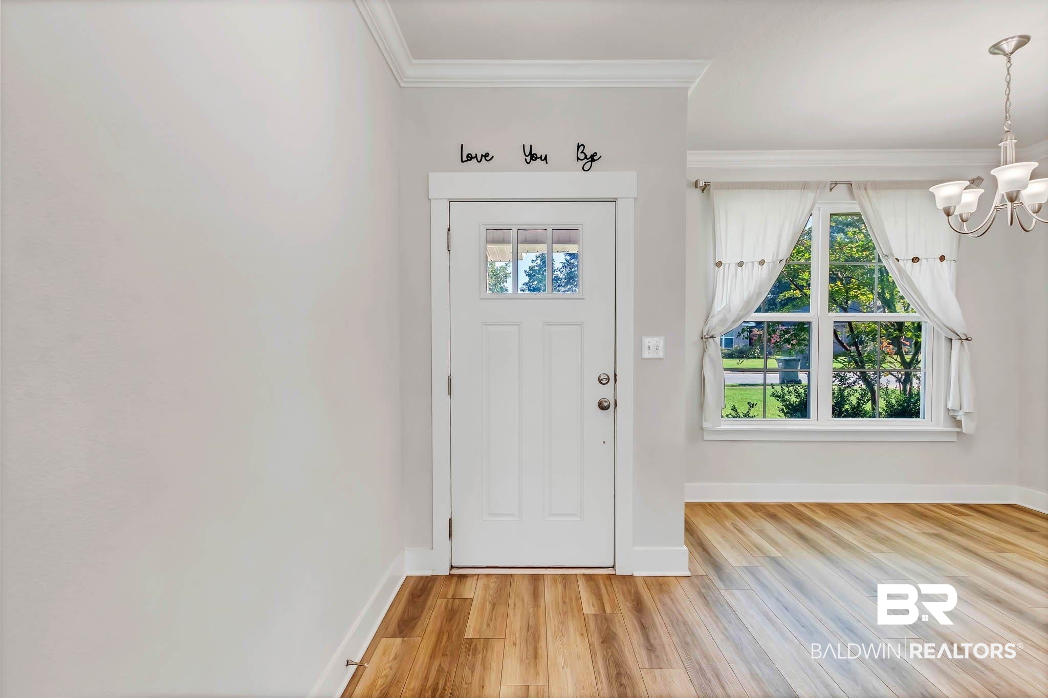 16461 Prado Loop Loxley, AL 36551 - Photo 3 of 78 Entrance foyer featuring ornamental molding, light wood-style floors, and a chandelier