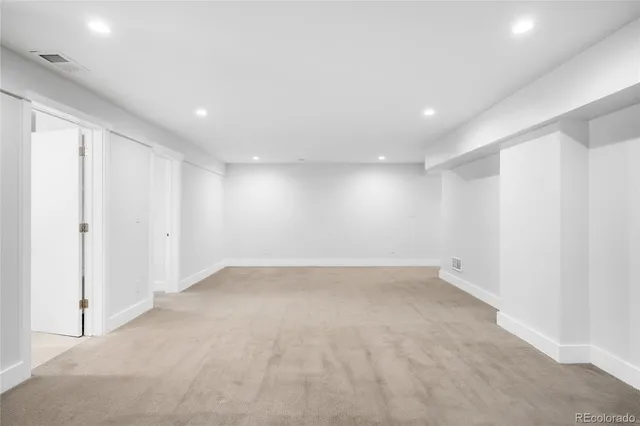 an empty room with a empty space and windows