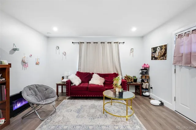 a living room with furniture and kitchen view