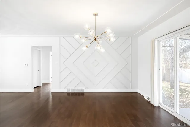 a view of a kitchen with wooden floor and a ceiling fan