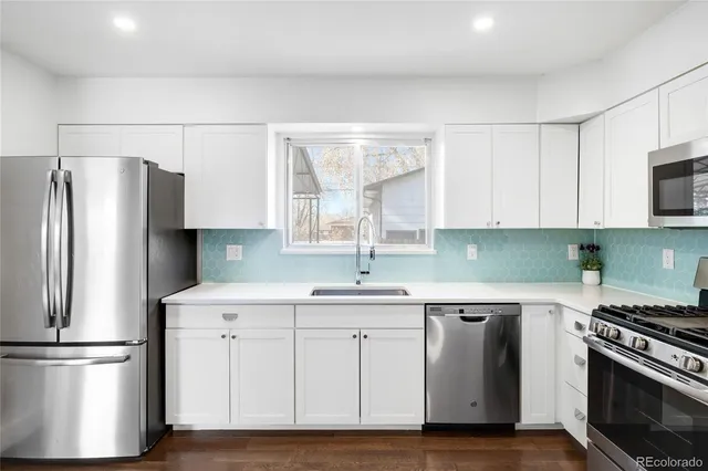 a kitchen with a stove oven and sink