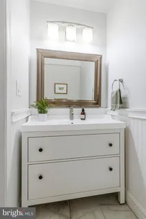 a bathroom with a sink vanity and mirror