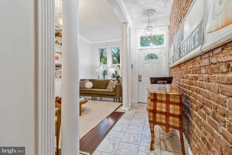 a balcony with furniture and a potted plant
