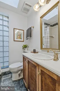 a bathroom with a sink a toilet and mirror
