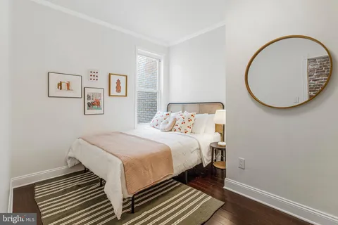 a bedroom with a bed and a mirror