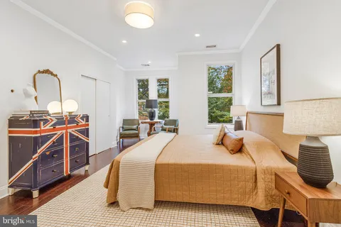 a bedroom with a bed and a wooden floor