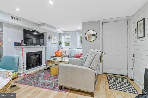 a living room with furniture a fireplace and a flat screen tv