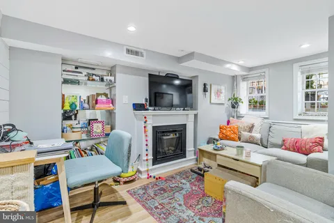 a living room with furniture fireplace and flat screen tv