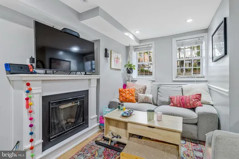 a living room with furniture and a fireplace